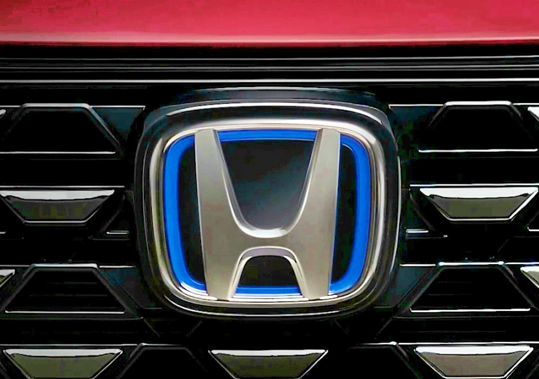 Teaser mobil baru Honda yang menampilkan gril dan emblem hybrid e:HEV. (Foto: tangkapan layar di situs Honda-indonesia.com)
